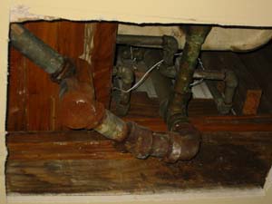 Old, galvanized pipes in the bathroom (seen from the hole in the living room ceiling).
