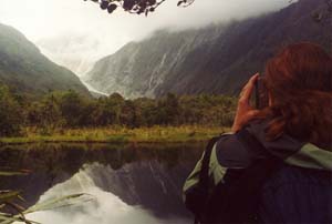 Sarah takes a photo at Peter's Pool of Franz Josef glacier.